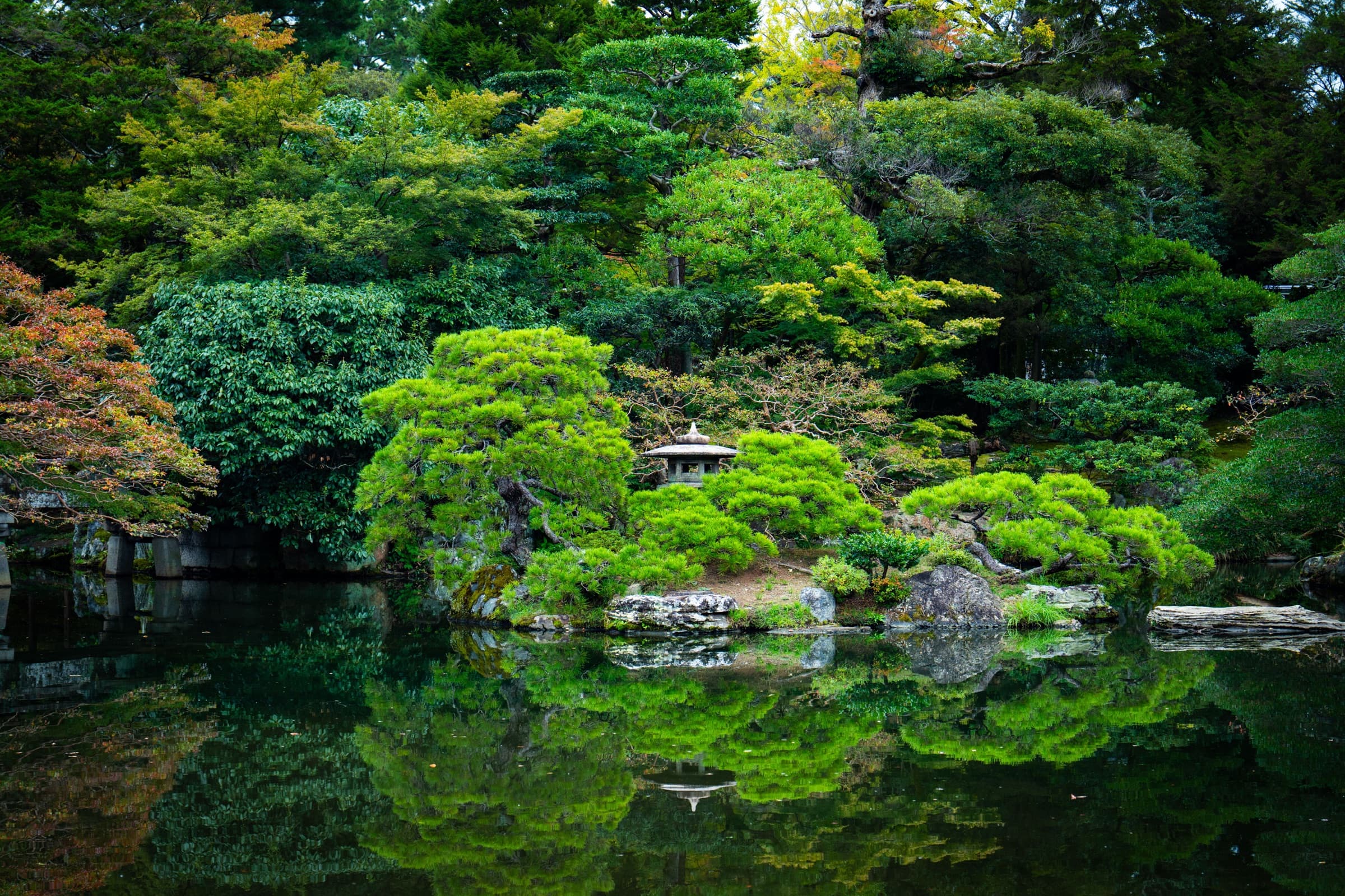 A quiet Japanese garden reflected on the water